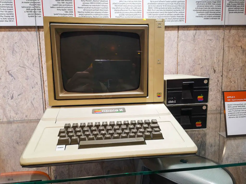 Der Apple II Computer mit Tastatur, Monitor und Diskettenlaufwerk auf einem Schreibtisch.
